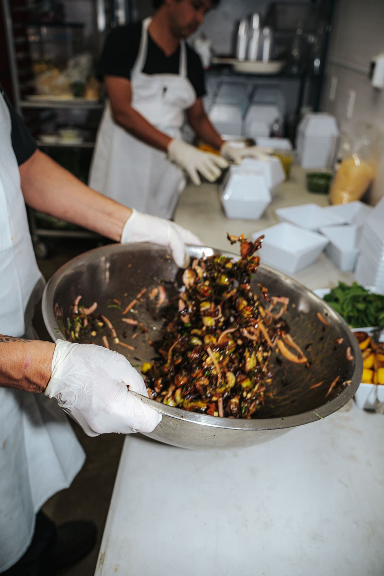 The crew tossing a salad in the kitchen